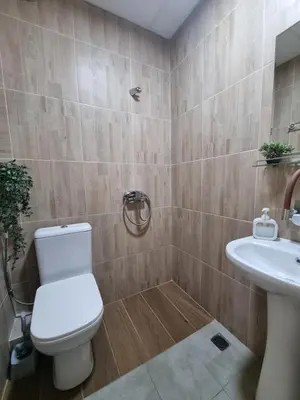a bathroom with a toilet and a sink at Dezudava Family Hotel in Sandanski
