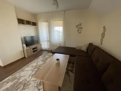a living room with a couch and a coffee table at Panorama view apartment in Sandanski