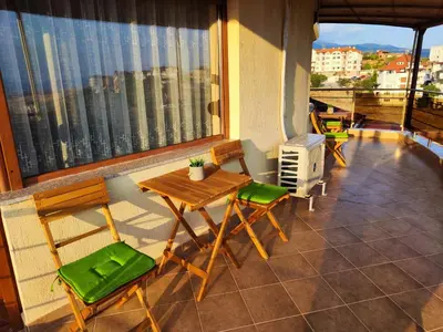 a balcony with a table and chairs on a balcony at Panorama view apartment in Sandanski