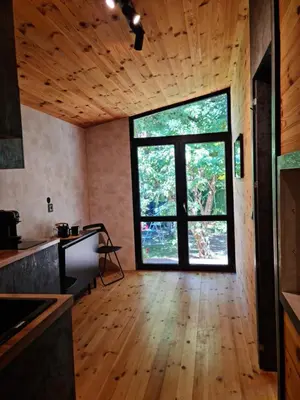 a kitchen with a large window and a wooden floor at Sofia Town House, FREE PARKING in Sofia