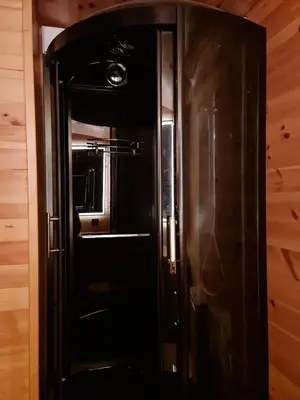 a black refrigerator in a room with wooden walls at Sofia Town House, FREE PARKING in Sofia