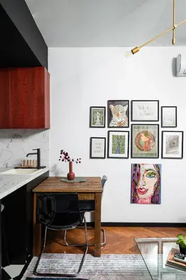 a kitchen with a wooden table and pictures on the wall at Central Art-Inspired Flat with Private Garage in Sofia