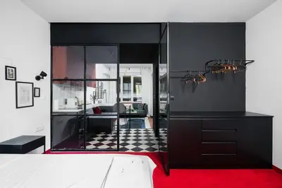 a living room with a room with a red carpet at Central Art-Inspired Flat with Private Garage in Sofia