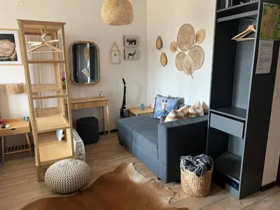 a living room with a blue couch and a shelf at Luxury Studio in Alpinе Lodge FREE SPA in Bansko