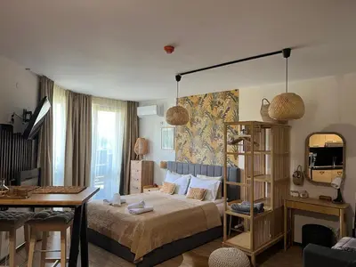 a bedroom with a bed and a table and a desk at Luxury Studio in Alpinе Lodge FREE SPA in Bansko