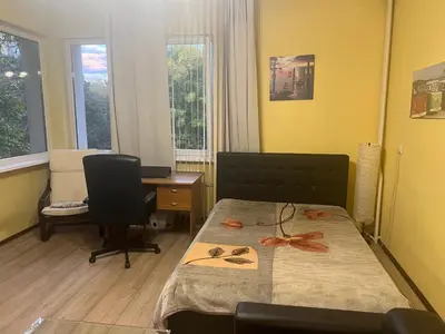 a bedroom with a bed and a desk with a computer at The Heart of Old Sofia (Shipka Street 24) in Sofia