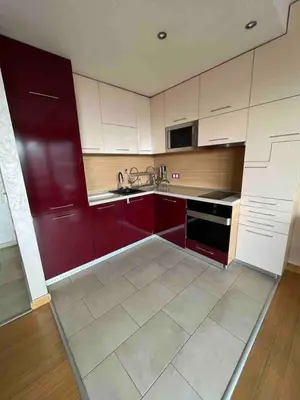 a kitchen with white and red cabinets and a sink at Silver city in Sofia
