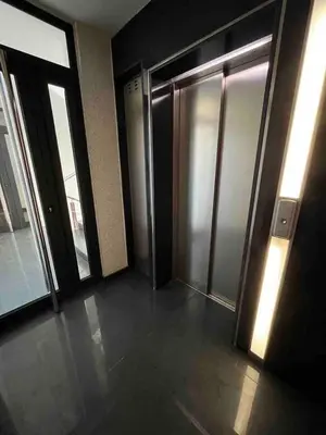 an empty hallway with doors and windows in a building at Silver city in Sofia