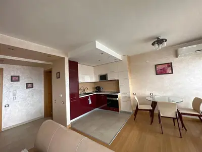 a living room and kitchen with a table and chairs at Silver city in Sofia