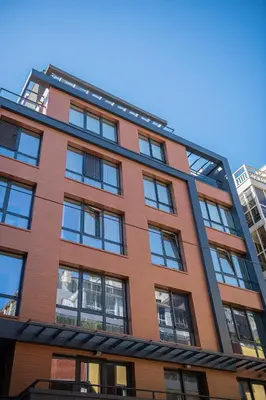 a tall building with windows on the side of it at Madrid: A modern 2-bedroom apartment with parking in Sofia