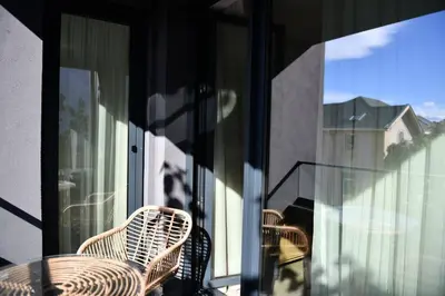 three chairs and a table on a balcony at Madrid: A modern 2-bedroom apartment with parking in Sofia