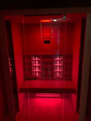 a red light in a room with a bench at Geneva: A charming patio studio with private parking! in Sofia
