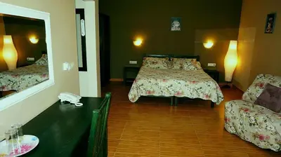 a hotel room with two beds and a mirror at Хотел Стиляна/Hotel Stilyana in Devin