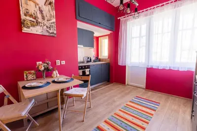 a kitchen with a table and a red wall at Beauty downtown - TOP CENTER in Sofia