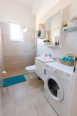 a bathroom with a washing machine and a toilet at Beauty downtown - TOP CENTER in Sofia