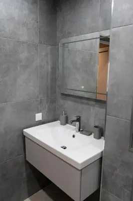 a bathroom with a white sink and a mirror at Urban Elegance by Eagles' Bridge in Sofia