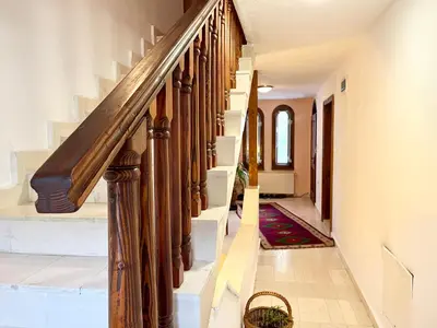 a staircase in a home with a wooden railing at Vila Omainiche Ribarica in Ribarica