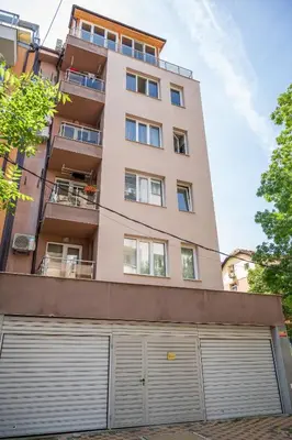 an apartment building with two garage doors in front of it at Elegant spotless apartment in Sofia Center in Sofia
