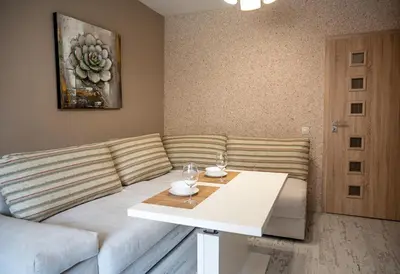 a living room with a couch and a table at Elegant spotless apartment in Sofia Center in Sofia