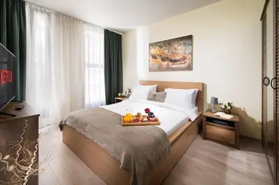a bedroom with a bed with a tray of fruit on it at New, Modern And Convenient in Sofia