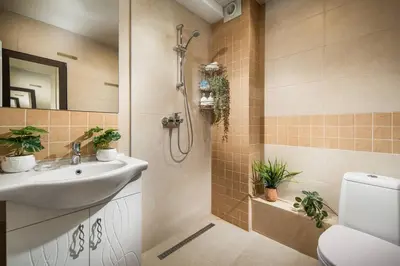 a bathroom with a sink and a shower with plants at New, Modern And Convenient in Sofia