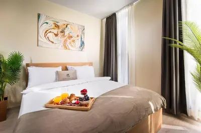 a bedroom with a bed with a tray of food on it at Free Parkingon Premises & Enjoy in Sofia
