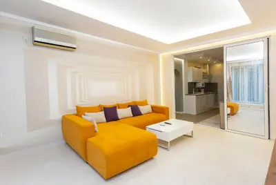a living room with a yellow couch and a table at Central Vitosha Apartment in Sofia