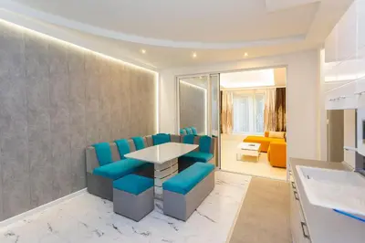 a dining room with blue chairs and a table at Central Vitosha Apartment in Sofia