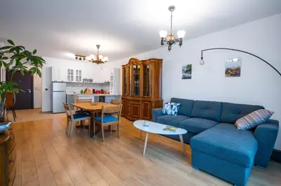 a living room with a blue couch and a table at Alla Prima - 1BD Flat in Sofia Centre by Flat Mаnager in Sofia