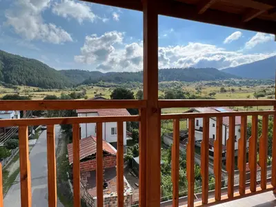 a view of the mountains from the balcony of a house at Alpine Nest: 6km to ski slopes in Beli Iskar