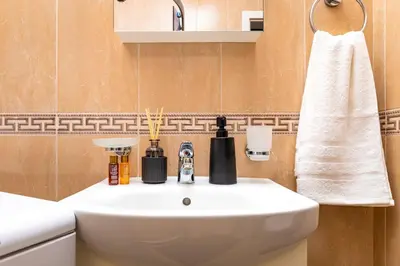 a bathroom with a white sink and a towel at Super Center flat Parchevich in Plovdiv