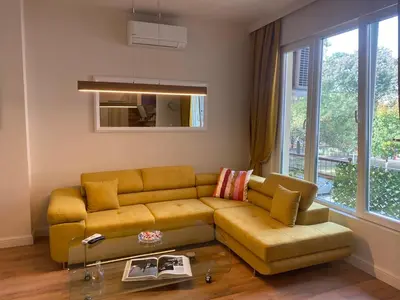 a living room with a yellow couch and a window at Casa Dell'Arte in Sofia