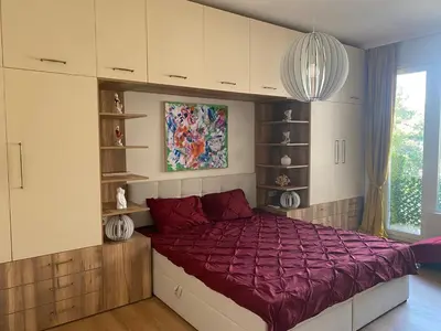 a bedroom with a large bed with a purple comforter at Casa Dell'Arte in Sofia