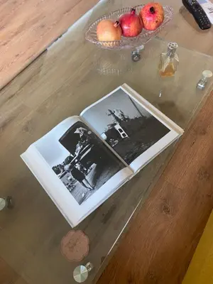 a book on a table with apples and a bowl of fruit at Casa Dell'Arte in Sofia