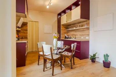 a kitchen and dining room with a table and chairs at Casa Dell'Arte in Sofia