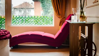 a pink chair sitting in front of a window at Casa Dell'Arte in Sofia