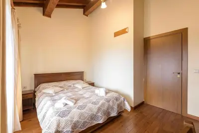 a bedroom with a bed with two pillows on it at Уютен апартамент с гледка в к-с Пирин Голф in Razlog