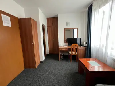 a room with a desk with a computer and a table at Family Hotel 007 Ivan Dimitrov-Kuklata 15 Str in Sofia