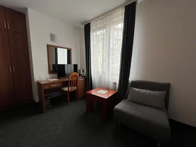 a room with a desk and a chair and a couch at Family Hotel 007 Ivan Dimitrov-Kuklata 15 Str in Sofia