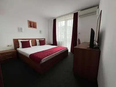 a hotel room with a bed and a television at Family Hotel 007 Ivan Dimitrov-Kuklata 15 Str in Sofia