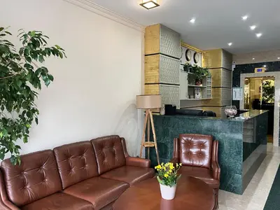 a living room with a couch and a table at Family Hotel 007 Ivan Dimitrov-Kuklata 15 Str in Sofia