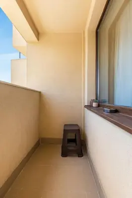 a small room with a stool in the corner of a building at Comfy Apartment with Private Parking in Plovdiv