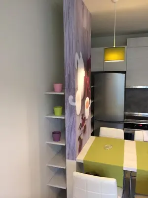 a kitchen with a yellow table and white chairs at Apartment South Park - Louis Eyer in Sofia