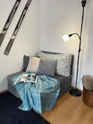 a living room with a couch and a lamp at Apartment for rest in Borovets in Borovets