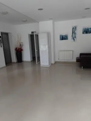 an empty room with a refrigerator and paintings on the wall at Apartment for rest in Borovets in Borovets