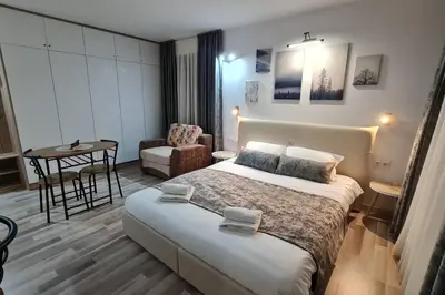 a hotel room with a bed and a chair at Monfort A in Bansko