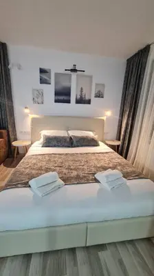 a bedroom with a large bed with two towels on it at Monfort A in Bansko