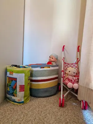 a room with a crib and toys in a corner at Bansko Royal Towers - 2BD Flat with Parking by Flat Mаnager in Bansko
