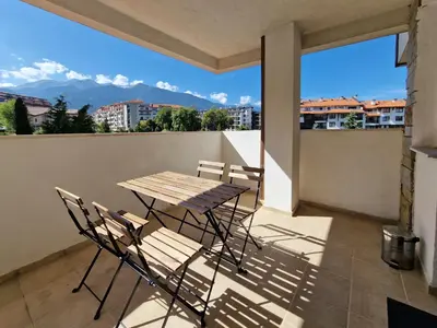 a table and chairs on a balcony with a view at Bansko Royal Towers - 2BD Flat with Parking by Flat Mаnager in Bansko