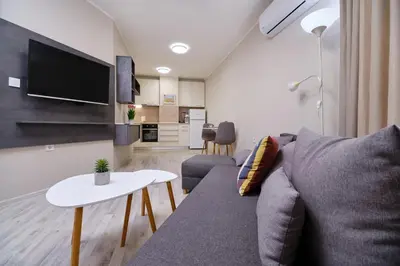 a living room with a couch and a table at Cozy 1-bed Apartment 2 in Plovdiv
